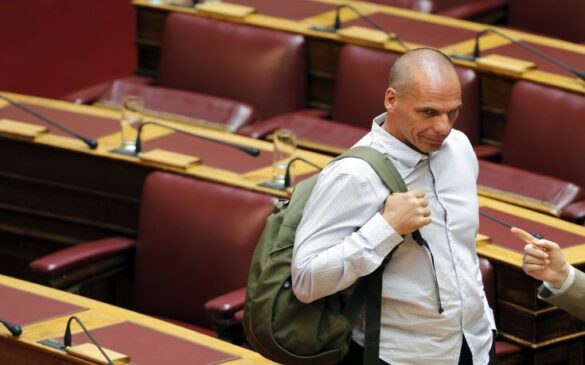 Greece's energy minister and head of the far-left flank of ruling Syriza party Panagiotis Lafazanis (R) points while talking with former Greek Finance Minister Yanis Varoufakis during a parliamentary session in Athens, Greece July 15, 2015. Prime Minister Alexis Tsipras battled to win lawmakers' approval on Wednesday for a bailout deal to keep Greece in the euro and avoid bankruptcy, as the IMF pressured Greece's creditors to provide massive debt relief for its crippled economy. REUTERS/Christian Hartmann